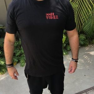 cool ass T- w/red writing that says: Inner Vibez on front & Manifest on back.